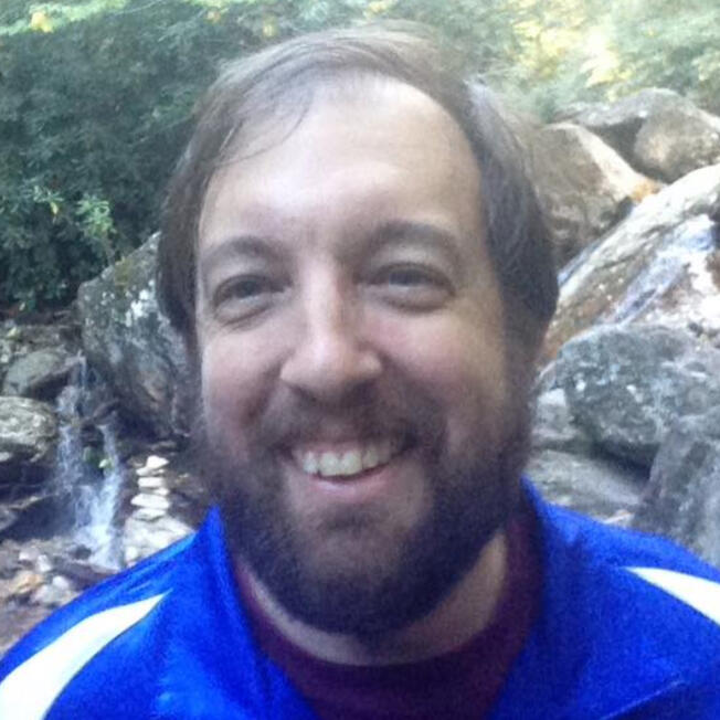 Smiling, bearded man